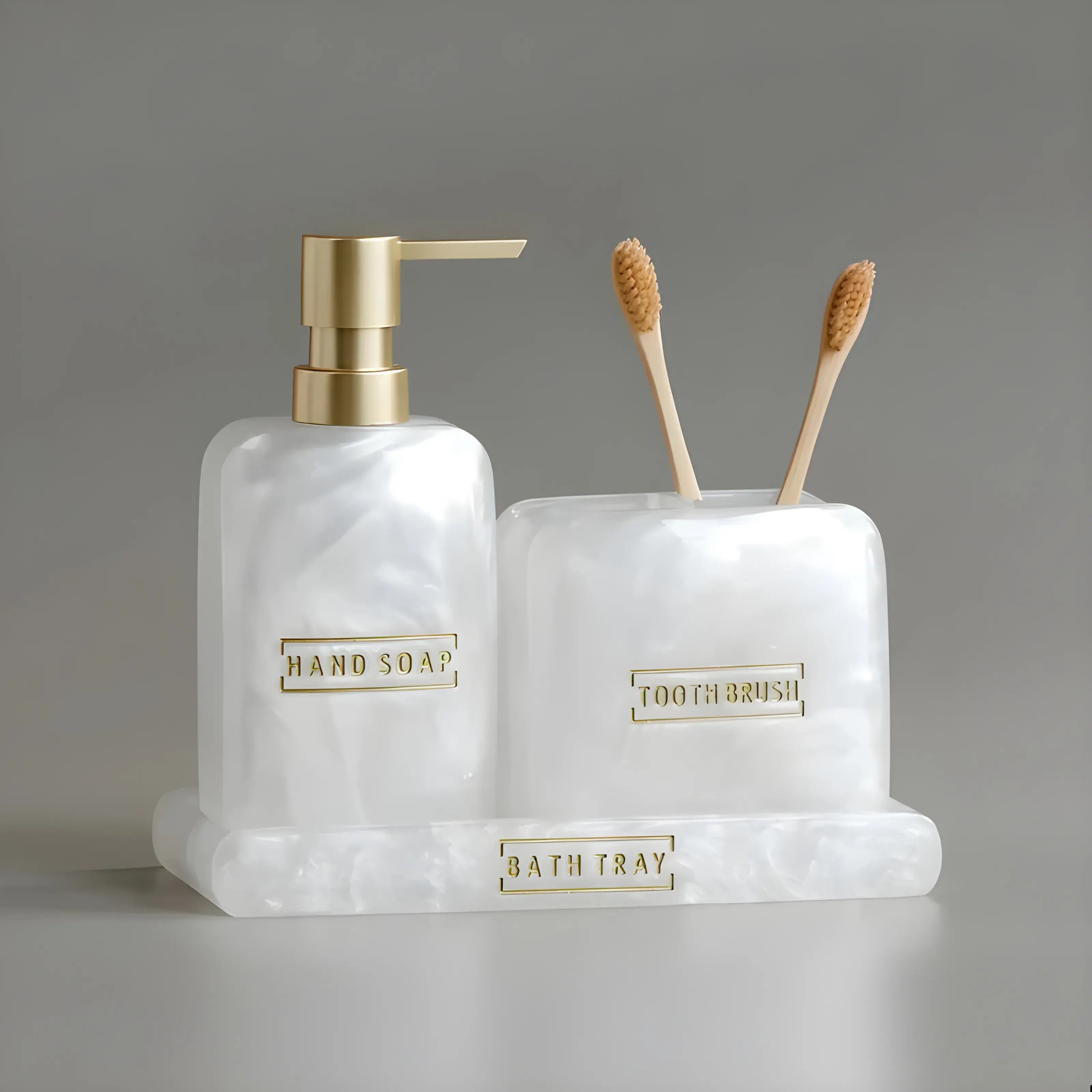 Kit Banheiro Lavabo Aura Perla, saboneteira e porta-escovas, detalhes dourados, organização elegante.