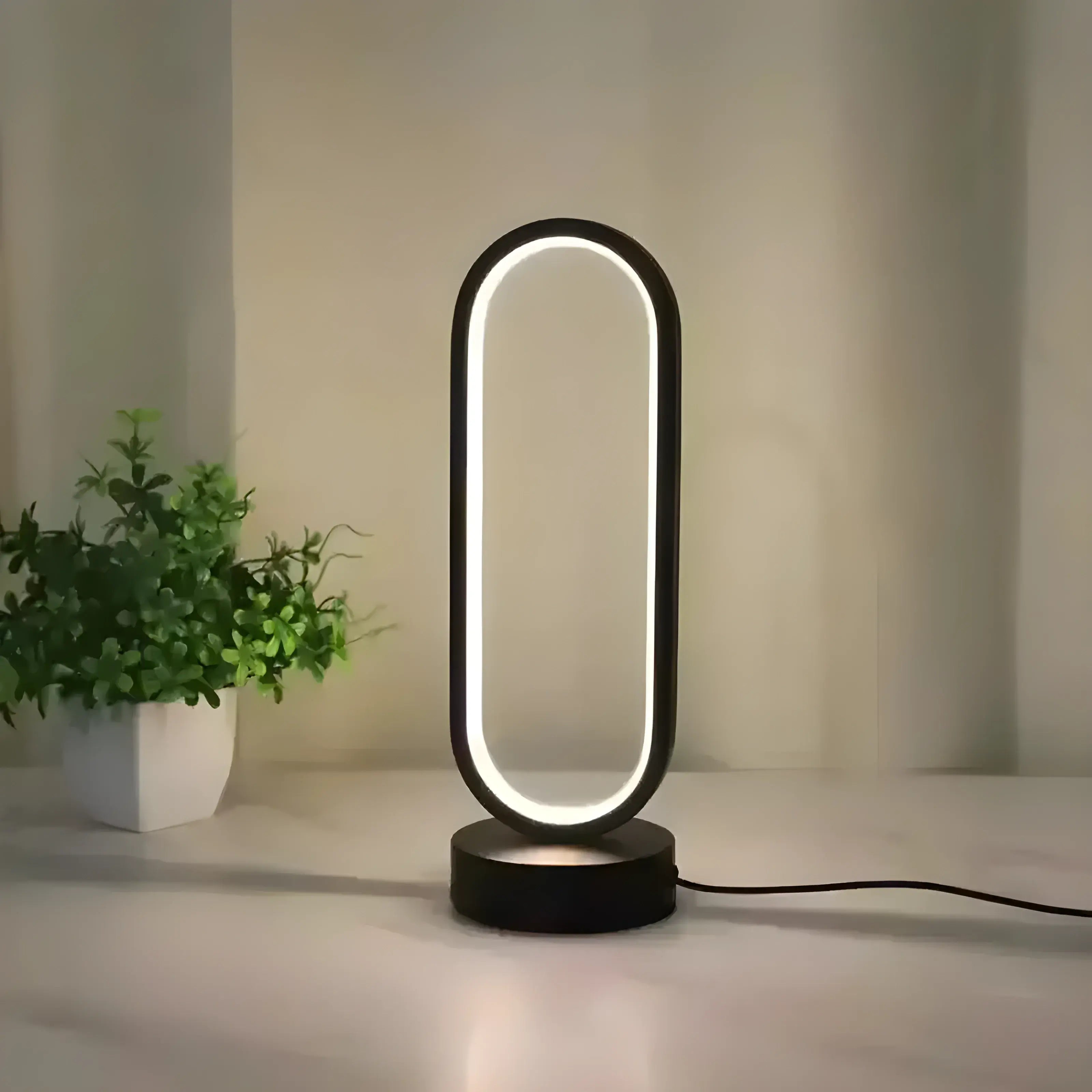 Luminária de mesa LED Aurévia Larvivaz com luz fria, design minimalista e acabamento em metal e acrílico.